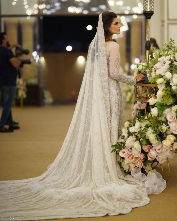 white bridal gown with long trail and embellishment