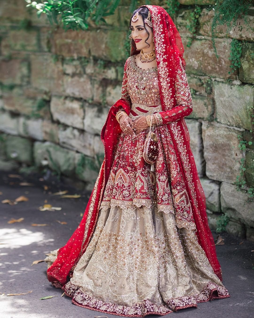 Photo of A bride in a red lehenga with peplum top wirling on her wedding day-gemektower.com.vn
