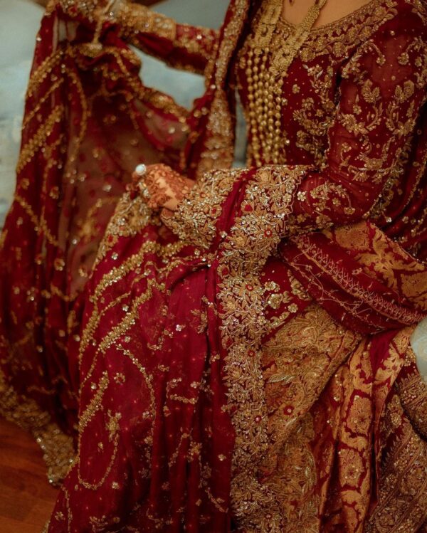 red and golden bridal long trail lehenga