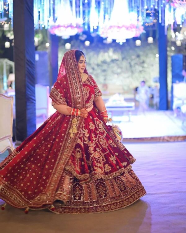 red velvet bridal lehenga with golden emrboidery