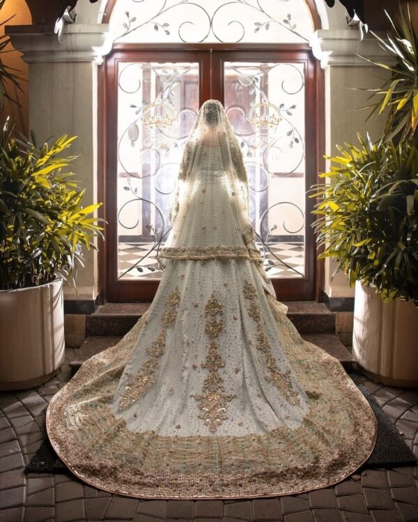 long trail wedding gown with golden embroidery