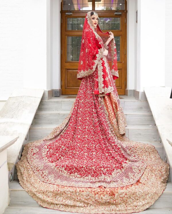 long trail wedding lehenga with golden embroidery