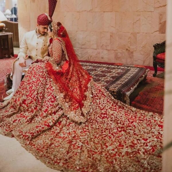 red long trail wedding lehenga with golden embroidery