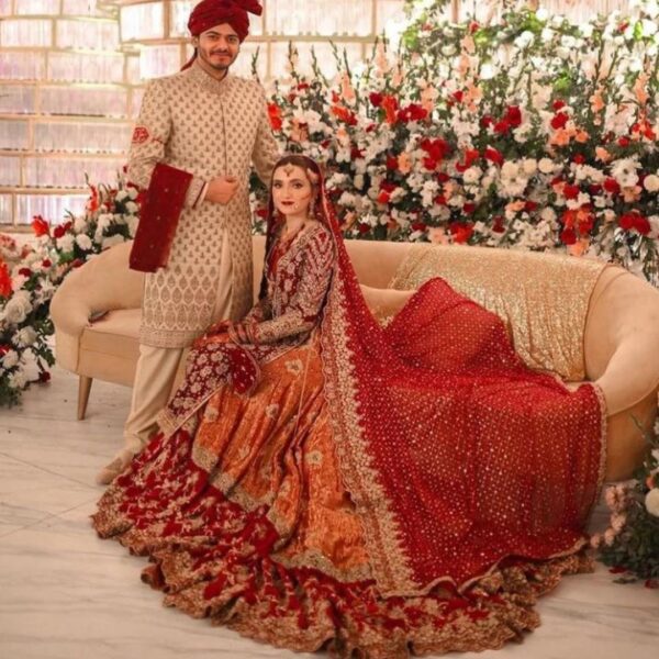 red long trail wedding lehenga with hand work
