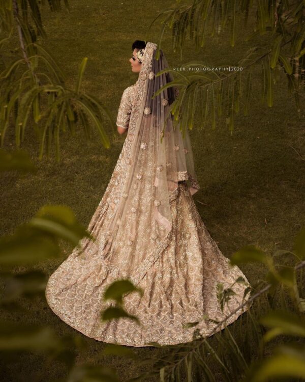 Golden bridal gown with long trail