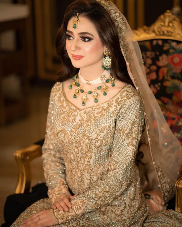 long trail wedding lehenga with golden embroidery