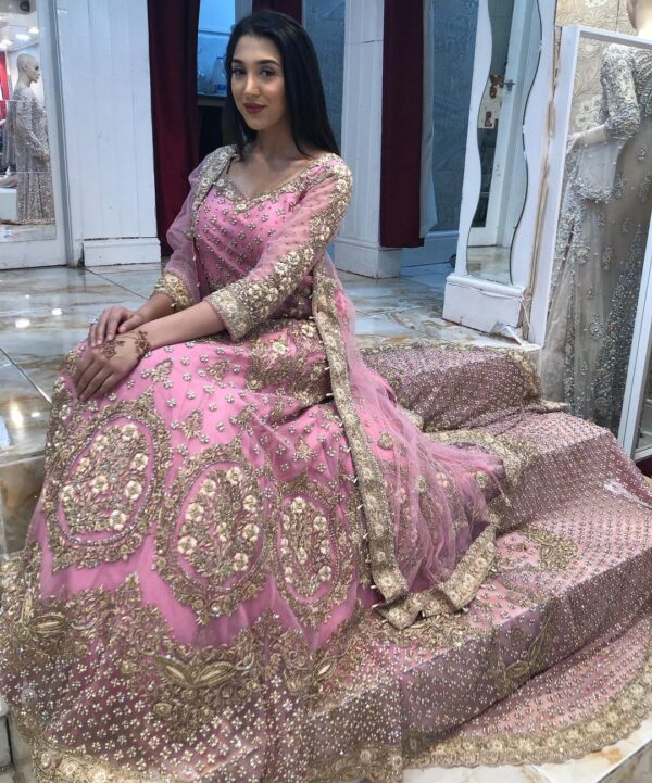 Pink and golden wedding long trail gown with pearls work