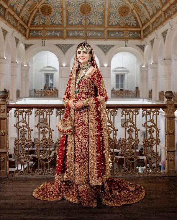 red embroidered bridal long trail lehenga with kurti