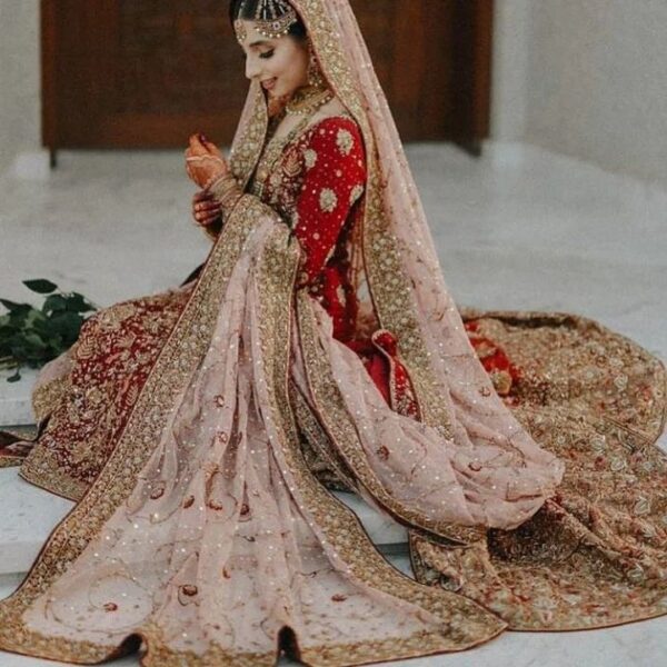 red and orange bridal long trail lehenga with kurti