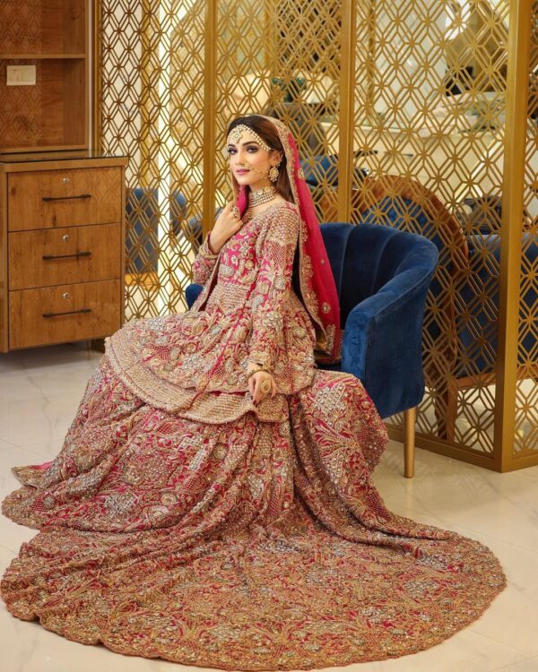 Red bridal long trail lehenga with peplum