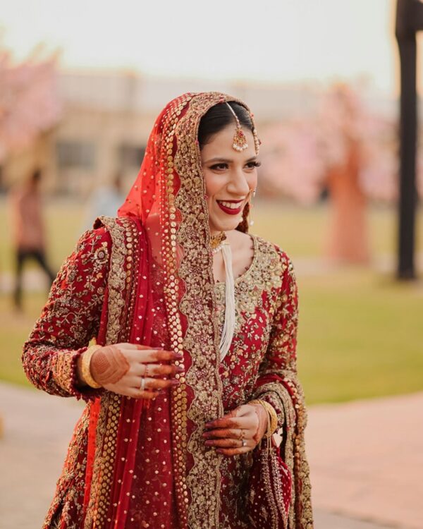 Red designer wedding long trail lehenga with handwork