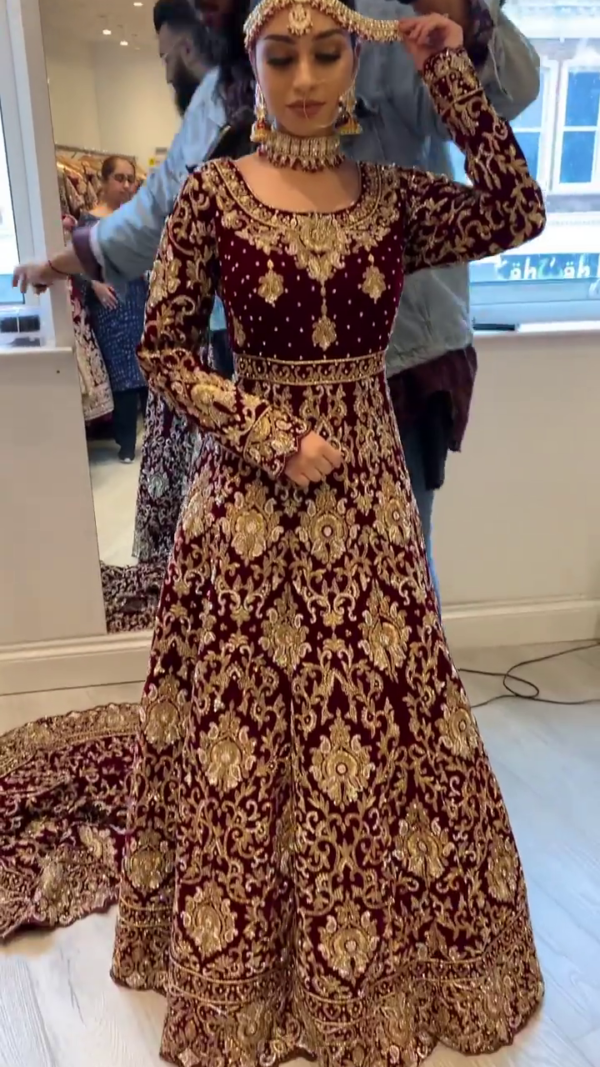 designer maroon wedding gown with long trail