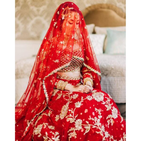 red bridal lehenga choli with long trail