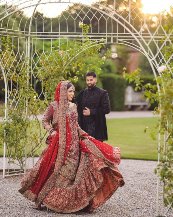 wedding red bridal long trail lehenga with handwork