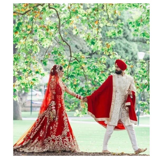 Red bridal long trail lehenga with embroidery