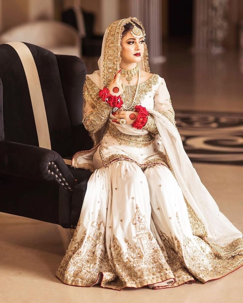 Designer garara with zari work
Walima reception bridal look
Ivory gold Pakistani garara
