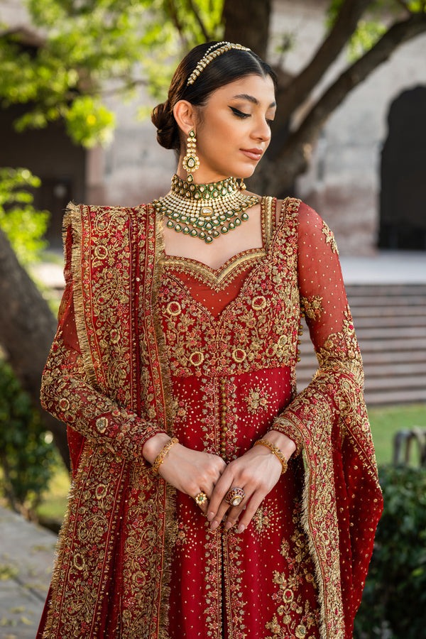 Side view of red bridal lehenga anarkali showcasing embellished sleeves and hand-embroidered dupatta border Side view of red bridal lehenga anarkali showcasing embellished sleeves and hand-embroidered dupatta border