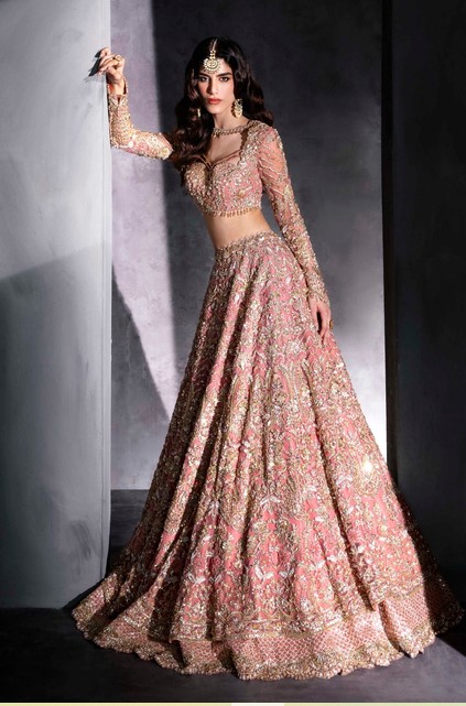 Hand-embroidered designer pink lehenga choli for wedding and reception wear.