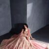 Designer Pakistani style bridal lehenga set in blush pink and gold.