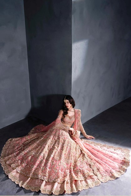 Designer Pakistani style bridal lehenga set in blush pink and gold.