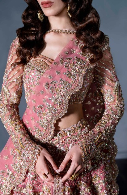 Heavy embellished pink Indian wedding lehenga with full sleeves choli.