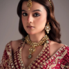 Close-up of a red bridal anarkali lehenga featuring traditional gold embroidery