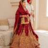Traditional red Punjabi bride wearing raw silk long choli and lehenga set