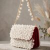 Compact pearl mini flap clutch showcasing exquisite beadwork